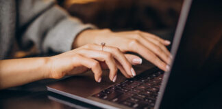 Female hands typing on computer keyboard