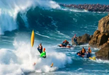 Ex-BBB Lucas “Chumbo” volta a vencer em Nazaré após duas quedas violentas e resgate; Justine Dupont conquista o feminino Imagem de Lucas "Chumbo" surfando em Nazaré após queda, equipes de resgate e ondas gigantes, clima tenso e energia.